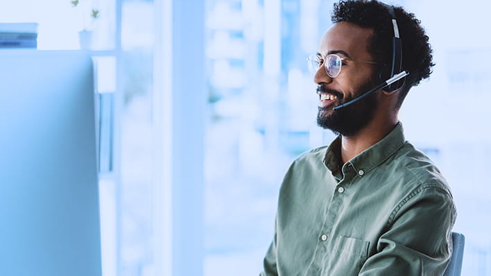 Man with headsets on working in an office