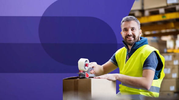 Man packing box in warehouse