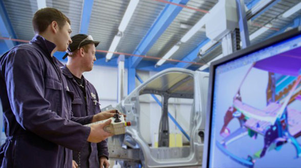 Two people working in car plant