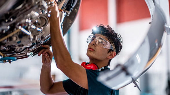 Man inspecting jet engine