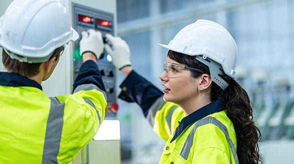 Two people working in factory