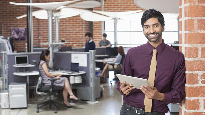 Man standing in office smiling