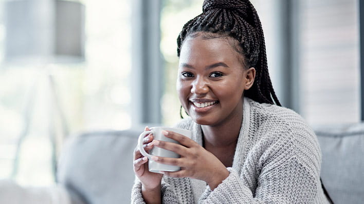 Woman with a hot drink smiling