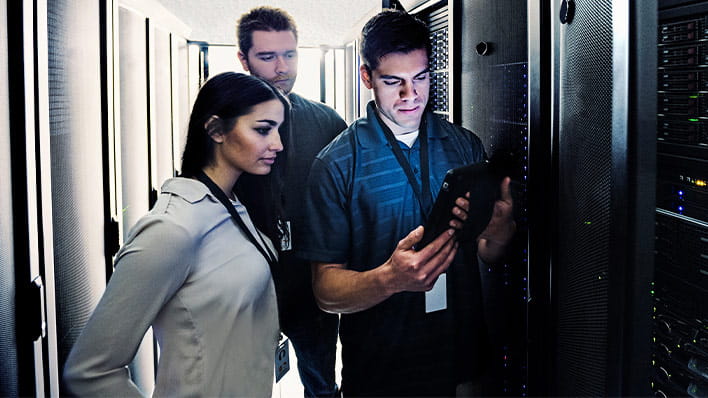 Three people in server room