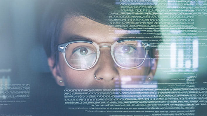 Person wearing glasses looking at data