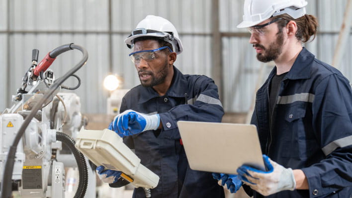 Two people inspectiing equipment