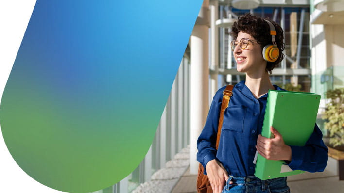 Person wearing heaphones carrying a folder.