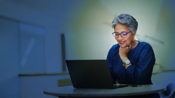 Person smiling looking at laptop