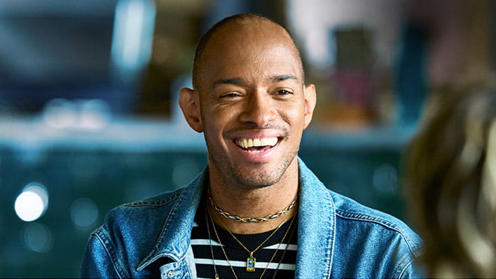 person in blue shirt smiling