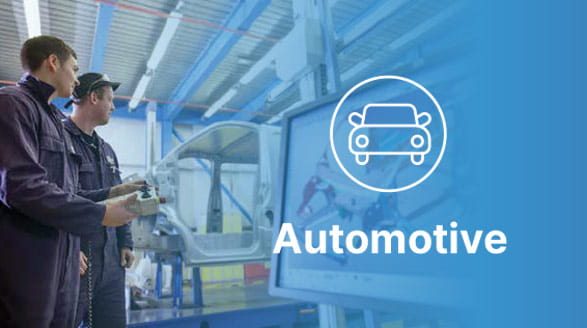 Two people working in car plant